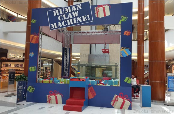 Get strapped to the “Human Claw Machine” at BurJuman