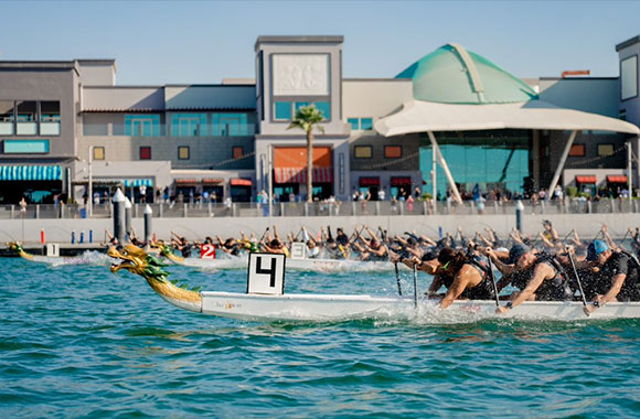 ONE BOAT ONE BEAT! The Dragons are Returning to the Waterfront Market this Month
