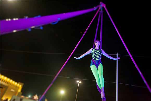 Unique Street Show Performers, Aerial Angels and Street Lamp Acrobatics, Strike Awe In to Global Village Visitors