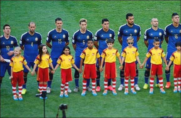 Lucky child from UAE walks players of the Grand Final match onto the pitch at The FIFA World Cup 2014 in Brazil