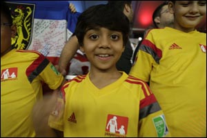 Lucky child from UAE walks players of the Grand Final match onto the pitch at The FIFA World Cup 2014 in Brazil