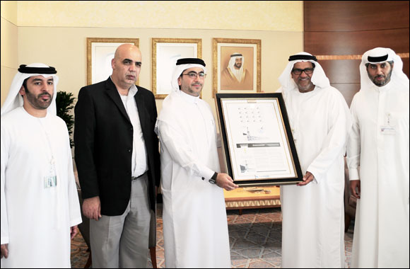 EPG presents ADCO with framed stamps on 50th Anniversary of 1st Crude Oil Shipment
